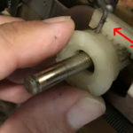 plastic piece with spring behind it